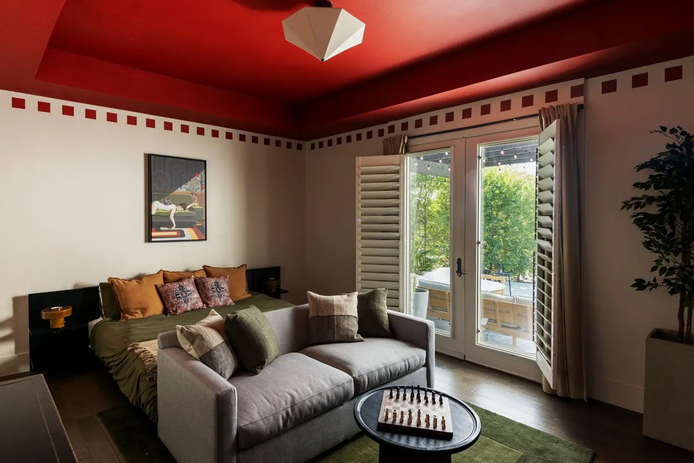 Designer bedroom suite with red ceiling at The Penrose House where eloping couples stay overnight near Dallas