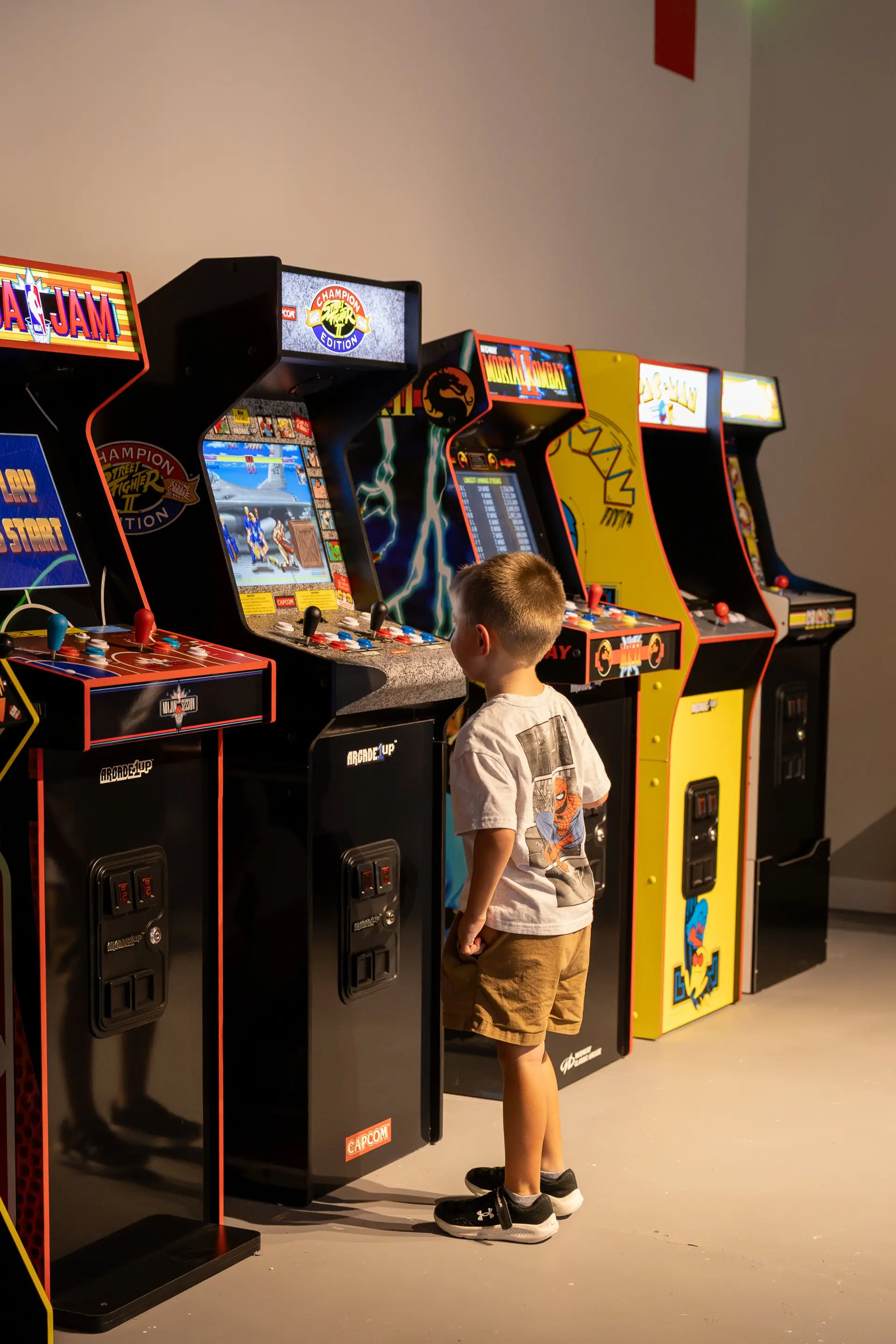 Guest playing vintage arcade games at The Penrose House entertainment area