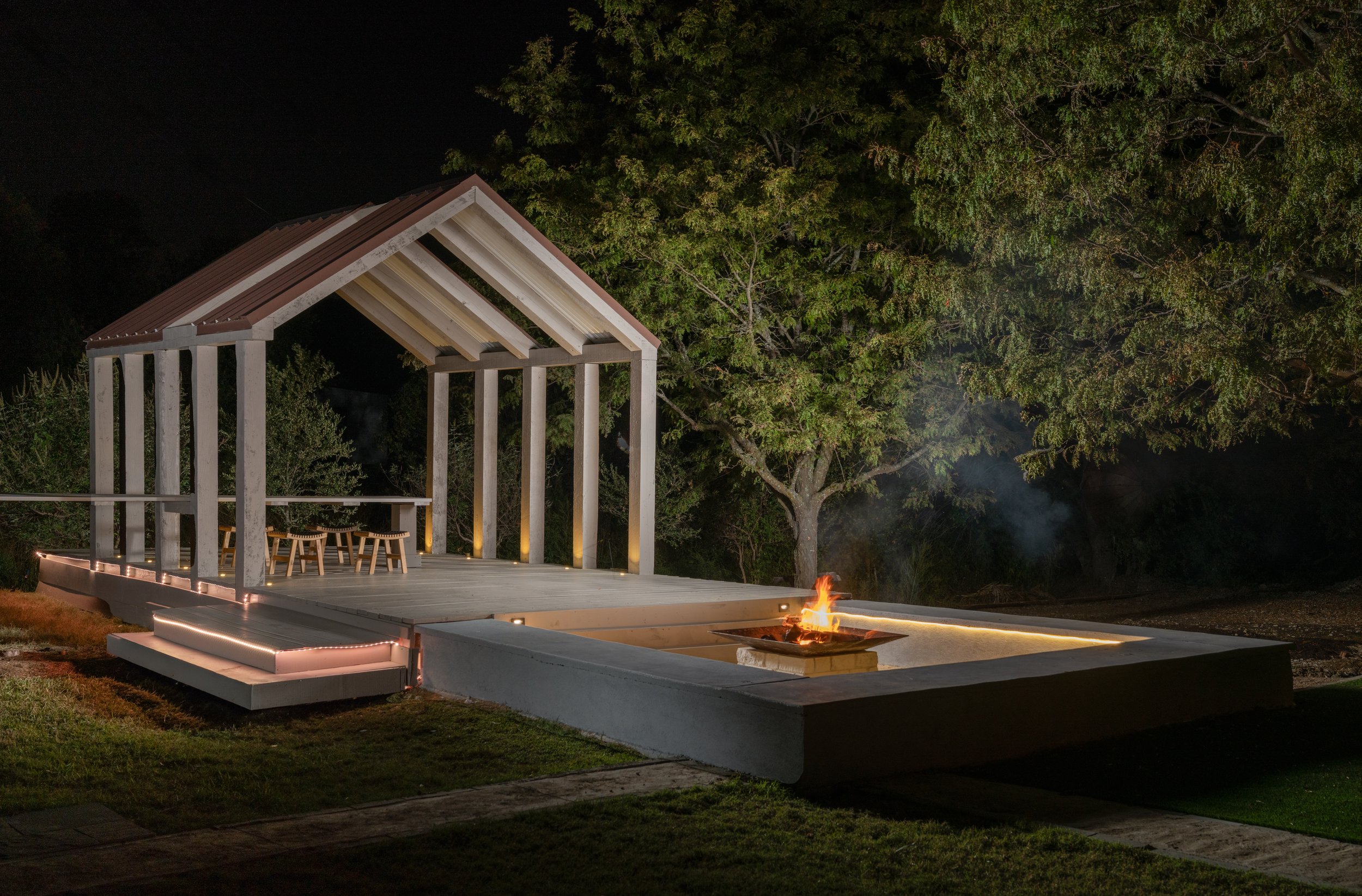 Evening gathering around the fire pit at The Penrose House after micro wedding reception