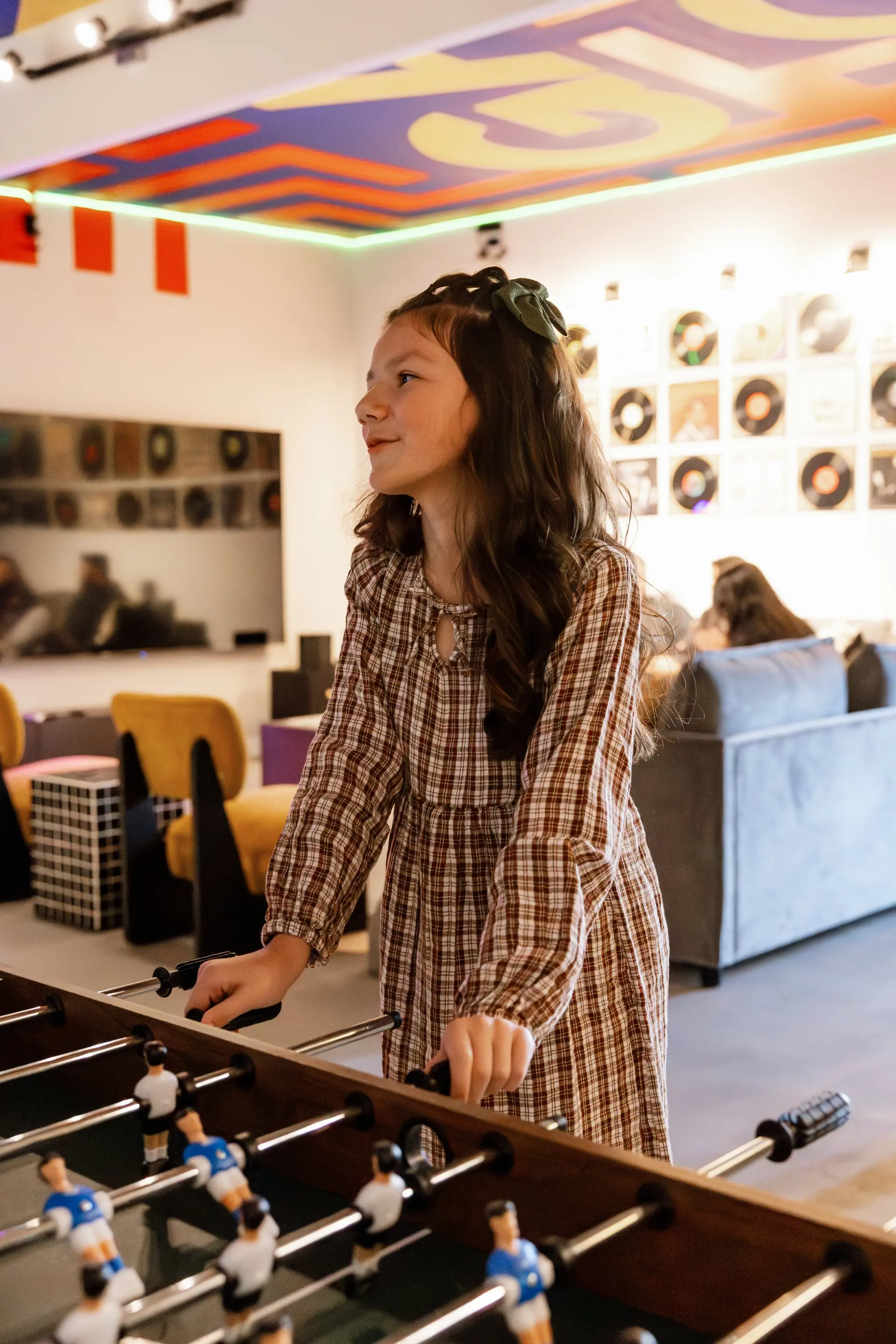 Guest playing foosball in the entertainment room at The Penrose House