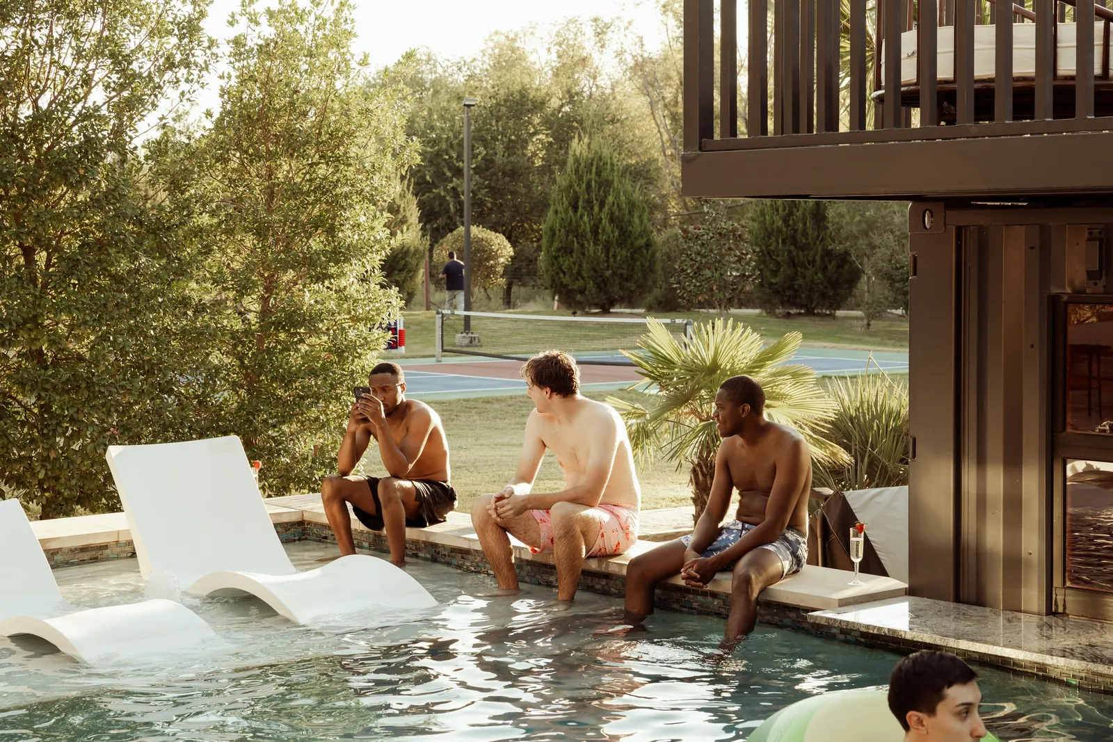 Guests relaxing by the resort-style pool at The Penrose House estate