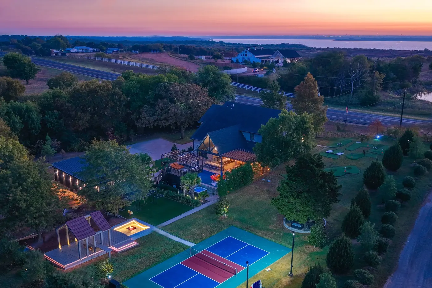 Twilight wide view of The Penrose House estate Princeton TX