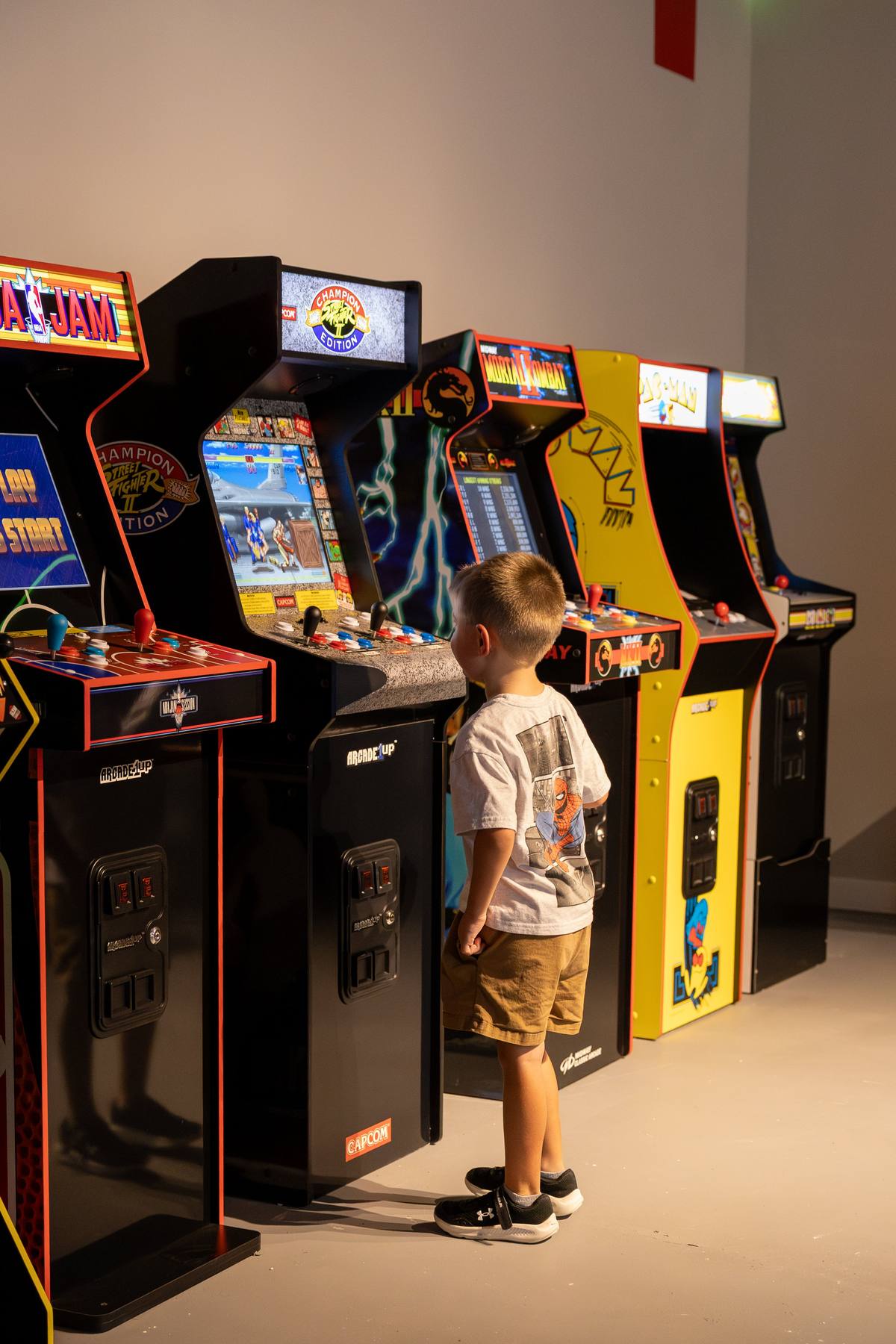 Row of classic arcade machines in the Plus One Lounge, The Penrose House