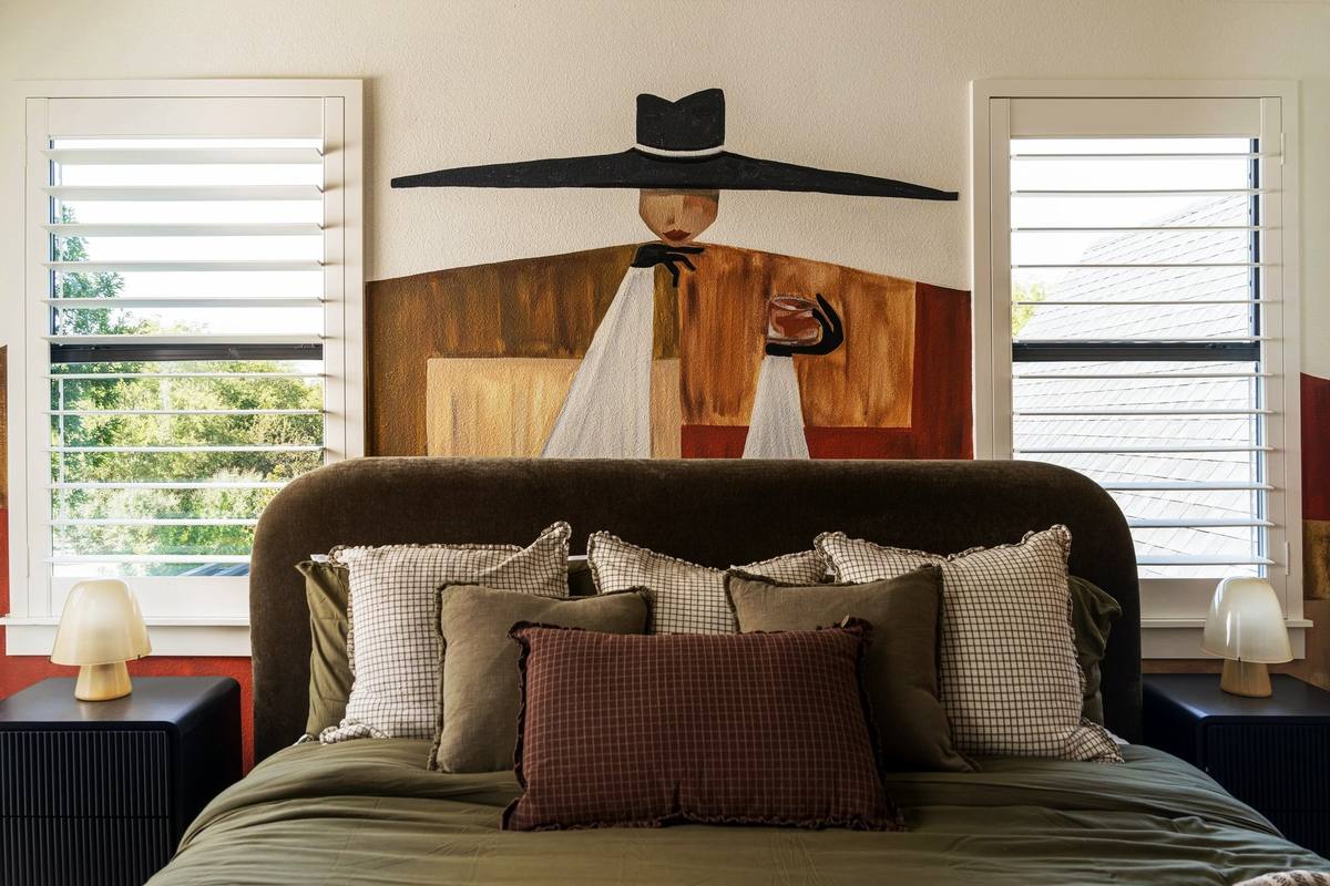 Bedroom with cowboy art above the headboard, The Penrose House
