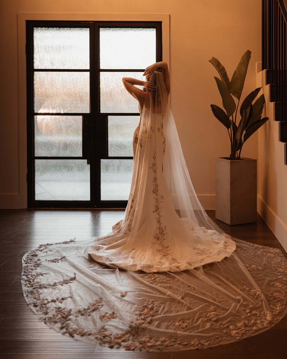 Bride with a cathedral-length lace veil in the foyer, The Penrose House