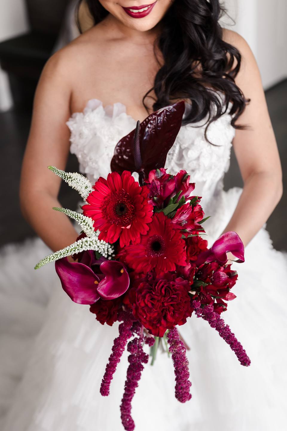 Bride holding a red and burgundy bouquet, The Penrose House