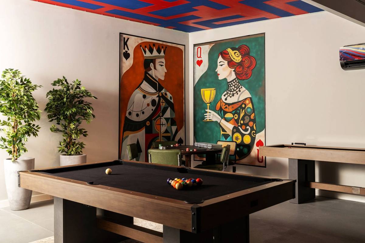 Pool table under the king and queen card murals in the game room, The Penrose House