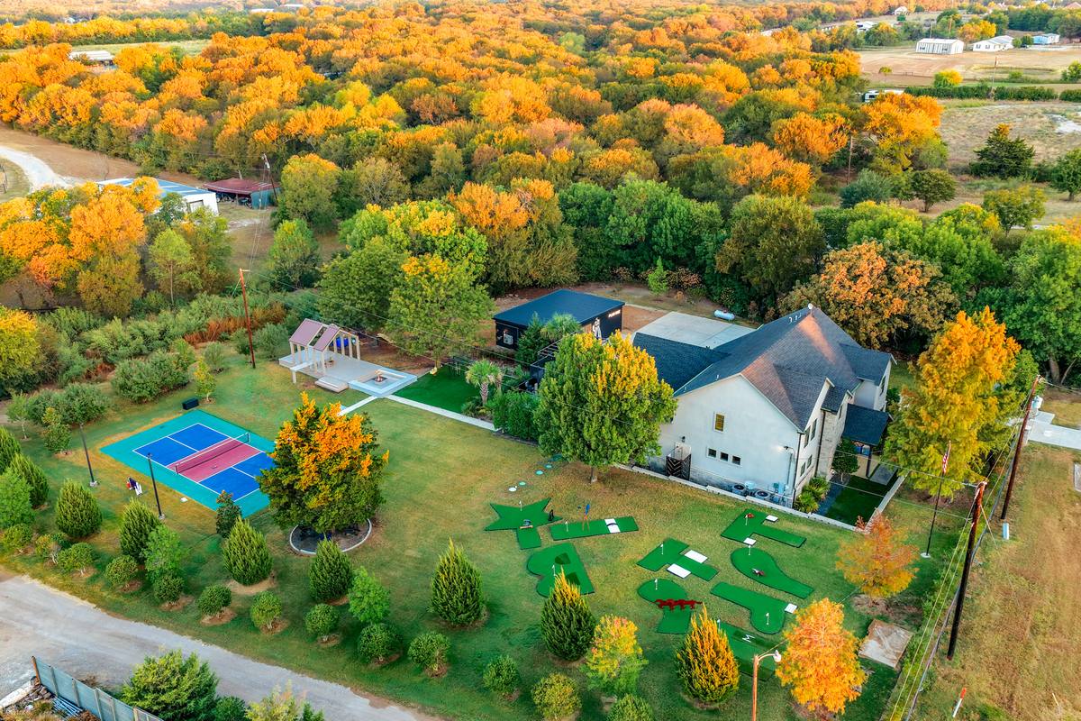 Aerial view of The Penrose House estate in fall with the pool, pickleball court and mini-golf on 5 acres