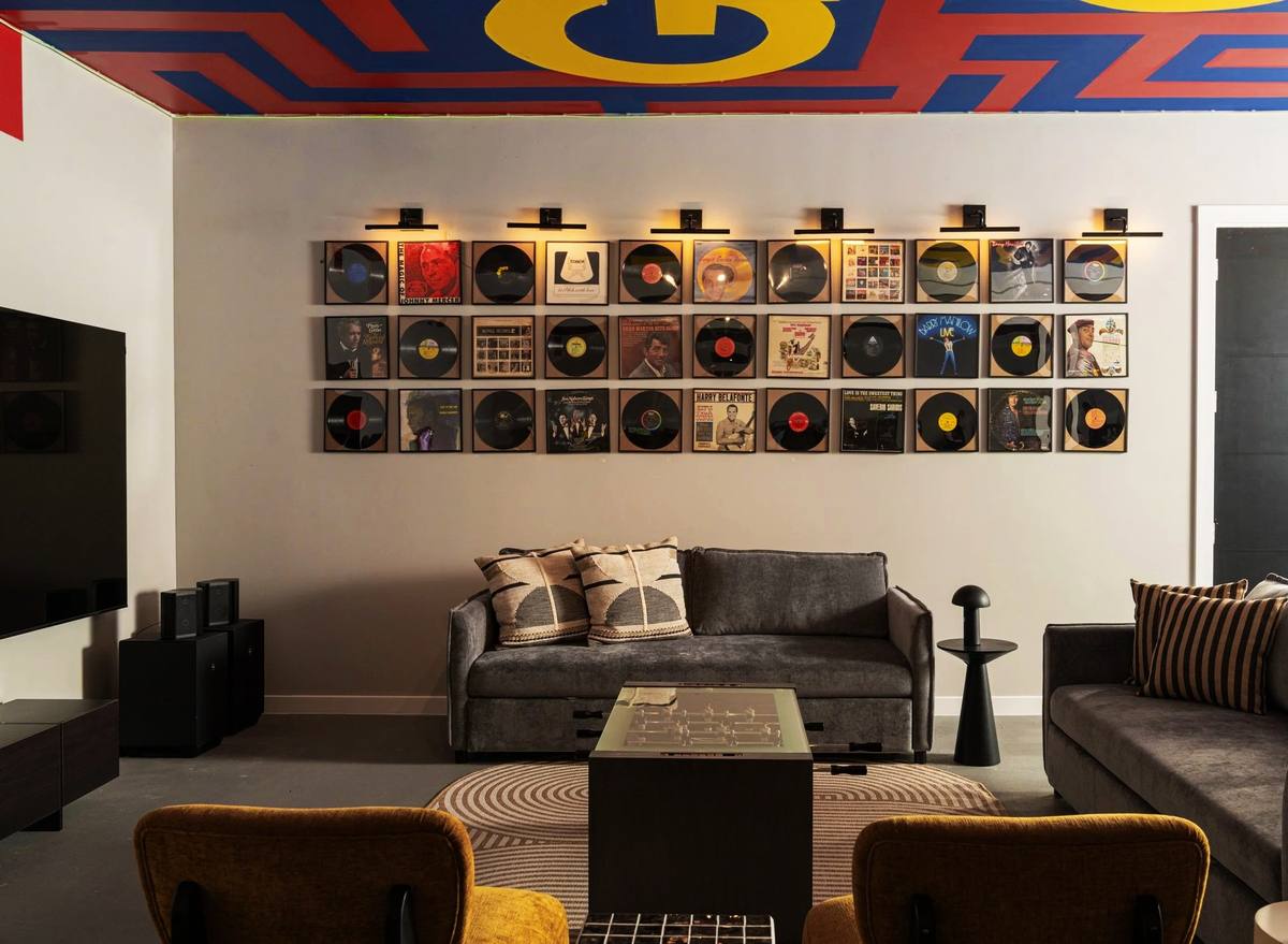 Plus One Lounge seating area with framed vinyl record wall, The Penrose House