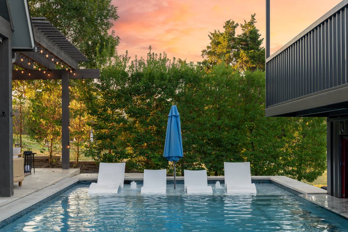 In-pool loungers and umbrella at dusk, The Penrose House