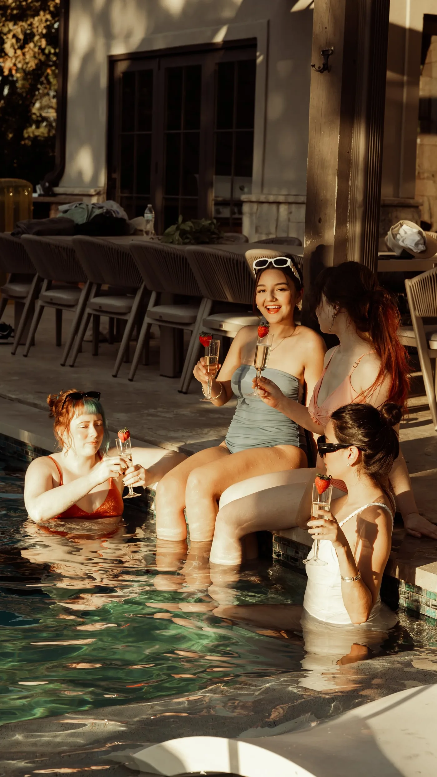 Champagne toast by the pool at sunset after an elopement at The Penrose House near Dallas